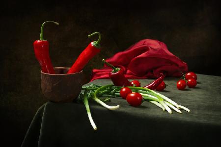 Stillleben mit roter Paprika,Tomaten und Zwiebeln auf dem Tisch