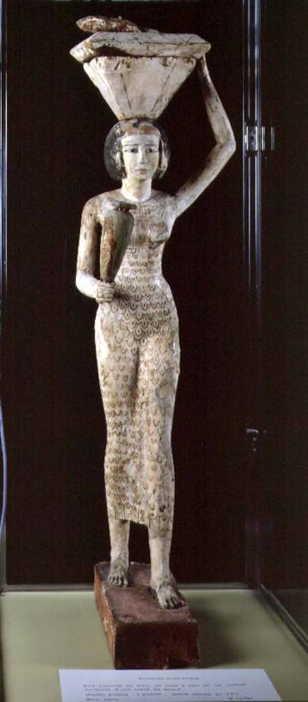 Female bearer of offerings carrying a water vase in her hand and a vessel on her head von Egyptian