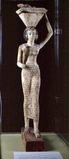 Female bearer of offerings carrying a water vase in her hand and a vessel on her head c.1950 BC