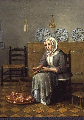 A Seated Woman preparing Food in a Kitchen