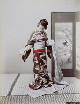 Young Japanese Girl Dressing, late 19th century (hand coloured photo) 19th
