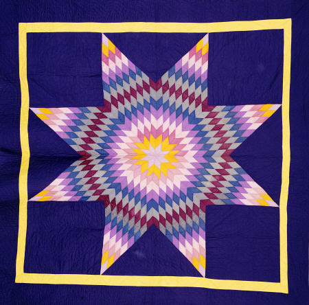 An Amish Pieced & Quilted Cotton Coverlet Worked In A Multicolored Lone Star On A Navy Background von 