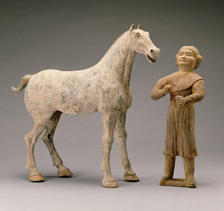 A Painted Grey Pottery Group Of A Horse And Groom von 