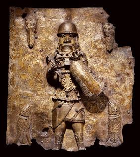 A Fine Benin Bronze Plaque In High Relief With A Warrior Chief, Full Length, In Elaborate Battle Dre