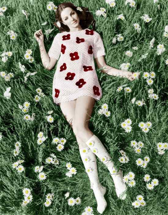 Young model Biddy Lampard in the grass wearing a short dress inspired by Courreges colourized docume von 