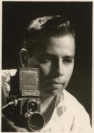Orlando Suero portrait with Rolleiflex camera, c 1954