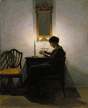 Woman reading by candlelight 1908