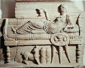 Detail from a sarcophagus depicting a woman reclining on a bench